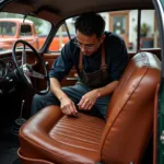 Craftsman meticulously restoring a vintage car interior