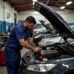 Mechanic inspecting a car in a Barbados repair shop