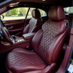 Bespoke car interior design with diamond-stitched leather seats and wood veneer accents