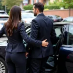 Professional chauffeur assisting a passenger