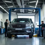 Modern car service center interior with a car on a lift and mechanics working.