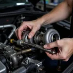 Mechanic Inspecting Car Turbocharger