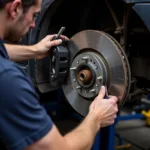 Mechanic inspecting the brake system of a car in Ilford