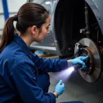 Mechanic Inspecting Car Brakes