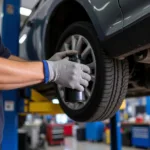 Car mechanic changing oil filter during car maintenance service