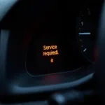 Car Dashboard Displaying Service Required Light