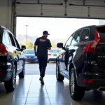 Service runner bringing car to service bay