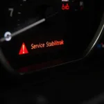 Car dashboard with Service Stabilitrak warning light illuminated