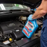 Toyota Technician Performing a Synthetic Oil Change at 10,000 Miles