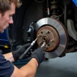 Mechanic Inspecting Brakes on a Leased Vehicle