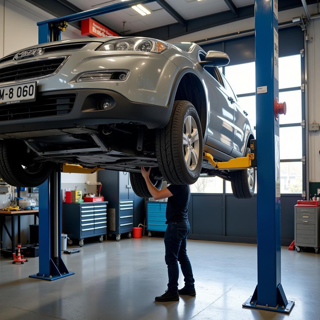 Car on a hoist in a service center