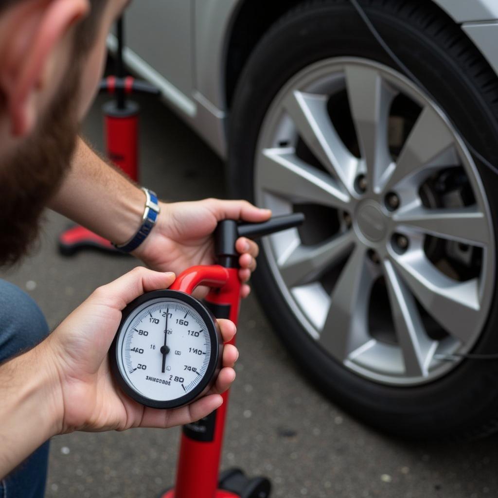 Checking tire pressure with gauge after using car foot pump