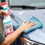 Person washing car using waterless car wash spray