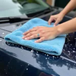 Drying a car with a microfiber towel after a self-service wash