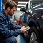 Mechanic Using Diagnostic Tool on Car