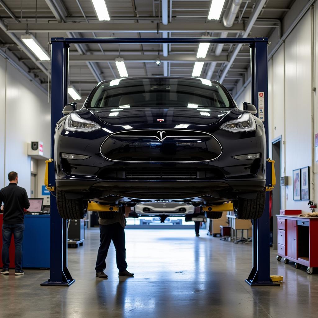 Tesla Car Undergoing Maintenance at a Service Center Lift