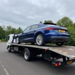 New Audi Being Loaded onto a Flatbed Truck