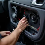 Car audio fitting service technician installing speakers in a car in Dover.