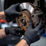 Close-up of a mechanic replacing brake pads on a car