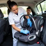 Technician professionally cleaning a baby car seat