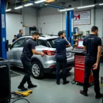 Car repair shop in Chennai with mechanics working on a vehicle